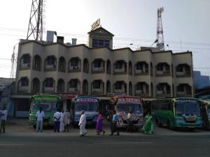a group of buses parked in front of a building at Kdk lodge in Pollāchi
