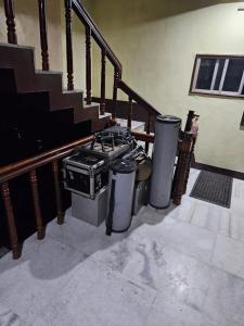 a kitchen with a stove and three trash cans at Kdk lodge in Pollāchi