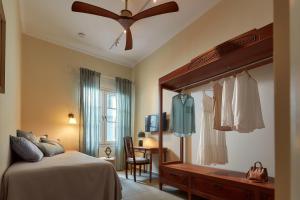 a bedroom with a bed and a ceiling fan at Vava Residence in Heraklio