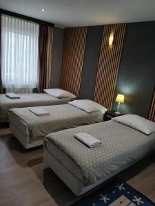 a hotel room with two beds and a window at Noclegi nad Morzem u Kasi in Gdańsk