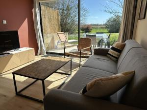 a living room with a couch and a table at Cozy Duplex in Arles