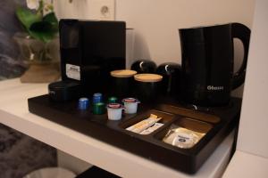 a black tray with a coffee maker on a counter at Pension y Apartamentos Txingurri Experience in Astigarraga