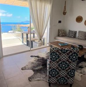 a living room with a couch and a view of the ocean at CasaEole B&B in El Haouaria