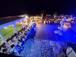 a group of people sitting in chairs at a party at night at Beach Club Ippocampo in Ippocampo