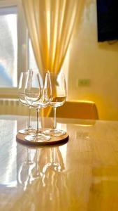 two wine glasses sitting on top of a table at Suite sogni di lago Lecco, Como in Malgrate +25 photos
