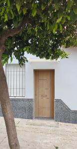 a wooden door on the side of a white building at Apartamento Katy in Seville