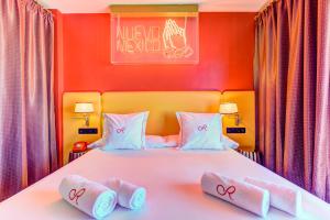 a bedroom with a bed with two towels on it at Romeos Ibiza - Adults Only in San Antonio Bay