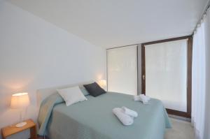 a bedroom with a bed with two towels on it at Els Llorers - Ref.050 in Begur