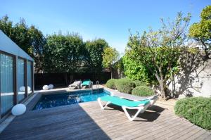 a backyard with a pool with a bench and a table at Els Llorers - Ref.050 in Begur +3 photos