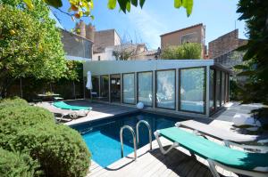 a swimming pool with chairs and a house at Els Llorers - Ref.050 in Begur