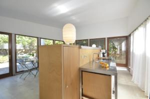 a kitchen with a counter and a large window at Els Llorers - Ref.050 in Begur