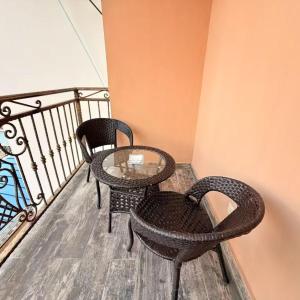 two chairs and a glass table on a balcony at Star Wish Business Hotel in Lagos