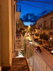 a balcony with a view of a street at night at B&B Le Residenze in Altamura