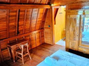 a room with a bed and a wooden wall at Pondok Kayu Canggu in Dalung +7 photos