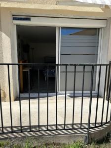 a garage door with a fence in front of it at LAVANDE studio 4 personnes in Château-Arnoux-Saint-Auban