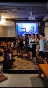 a group of people standing in front of a large screen at Karma Backpacker in Uluwatu +50 photos