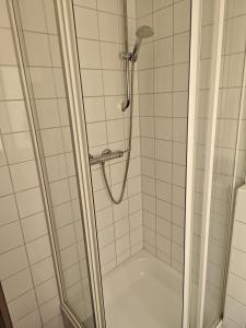 a shower with a glass door in a bathroom at Hotel am Markt Eschweiler in Eschweiler