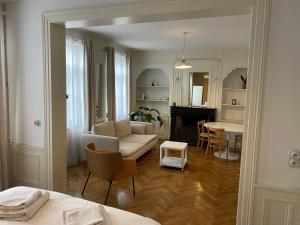 a living room with a couch and a table at La Parcelle in Lezennes