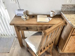 a wooden desk with a telephone and a printer on it at Hermosa Haven home in Montrose