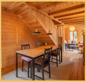 a dining room with a wooden table and chairs at Maison Méserier I T3 I Publier in Publier