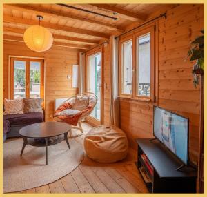 a living room with a tv and a table at Maison Méserier I T3 I Publier in Publier