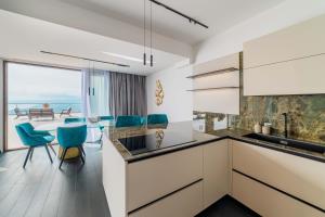 a kitchen with a view of the ocean at Dimora Eledia in Taormina