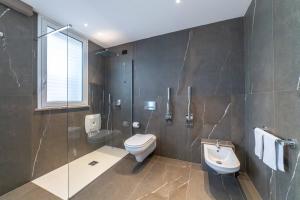 a bathroom with a toilet and a sink at Dimora Eledia in Taormina +48 photos