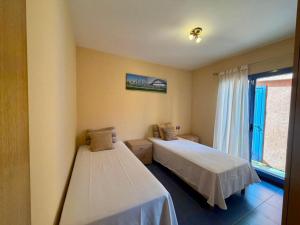 a room with two beds and a window at Montaña Blanca - Casa Bimba in Caleta De Fuste +38 photos