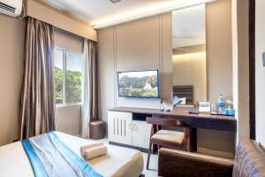 a hotel room with a desk and a mirror at Resort Atlantis in Dhalpur