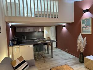 a small kitchen with a table in a room at Cozy Duplex in Arles