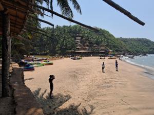 a group of people standing on a beach at Cupid's Heaven Resort in Agonda