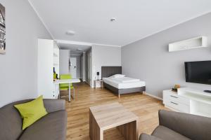 a living room with a couch and a bed at ADAPT APARTMENT HOTEL Wetzlar in Wetzlar