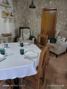 a dining room with a white table and chairs at Casa do Limoeiro - Casa in Golegã