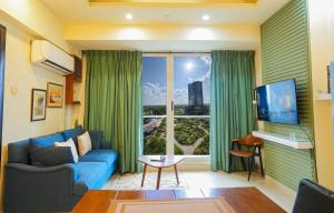 a living room with a blue couch and a large window at Elysium Tower Luxury Apartments Islamabad Opposite Centaurus Mall in Islamabad