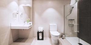a bathroom with a toilet and a sink and a shower at Pension y Apartamentos Txingurri Experience in Astigarraga +53 photos