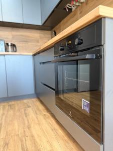 a kitchen with a black oven in a kitchen at Apartment in Irpin Pavlenka in Irpin