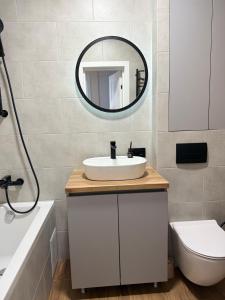 a bathroom with a sink and a mirror at Apartment in Irpin Pavlenka in Irpin +27 photos