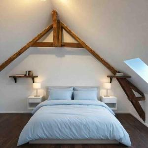 a bedroom with a large bed with wooden beams at KVS concept Écommoy chambres haut de gamme proche circuit 24 heures Le Mans in Écommoy +31 photos