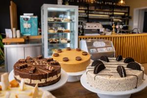 three cakes on plates on a table in a store at Romantic Sunset Retread I 4 Min to A2 I E-Bikes I Near Ljubljana in Velika Loka +9 photos