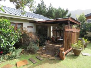 a house with a gazebo in the yard at Alpaca Self Catering Cottage Kleinmond in Kleinmond