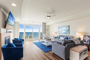 a living room with a couch and a tv at Turquoise 1908C in Orange Beach
