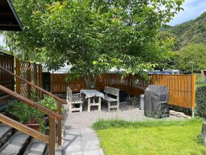 a backyard with a picnic table and a tree at Ferienhaus Elda in Lahnstein +2 photos