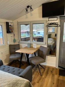 a living room with a table and chairs and a tv at Ferienhaus Elda in Lahnstein