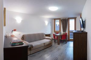 a living room with a couch and a table at Casa Beba in Bormio
