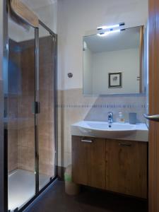 a bathroom with a sink and a shower at Casa Beba in Bormio +3 photos