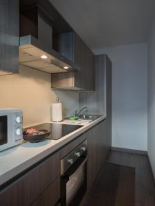 a kitchen with a sink and a microwave at Casa Beba in Bormio