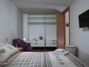 a bedroom with a bed and a large window at Casa Beba in Bormio