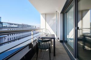 a balcony with a table and chair on a building at ADAPT APARTMENT HOTEL Wetzlar in Wetzlar