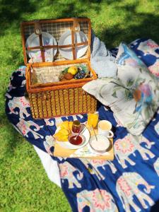 a picnic basket with a tray of food on a blanket at Studio 149 - Wild Coast Accommodation in Sunrise-on-Sea