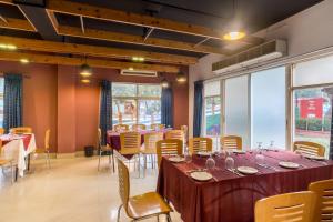 a dining room with a long table and chairs at Resort Atlantis in Dhalpur +54 photos